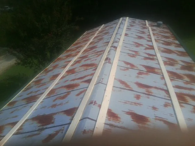 Rusted metal roof panels with new wood purlins before replacement — Storm Damage Roof Repair in El Centro by Roofing Brothers