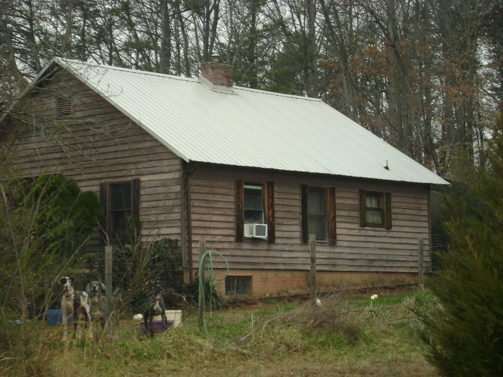White metal roof on an old wood sided farmhouse, from a Metal Roof Installation job in El Centro